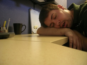 man taking nap at desk