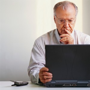 old man using computer